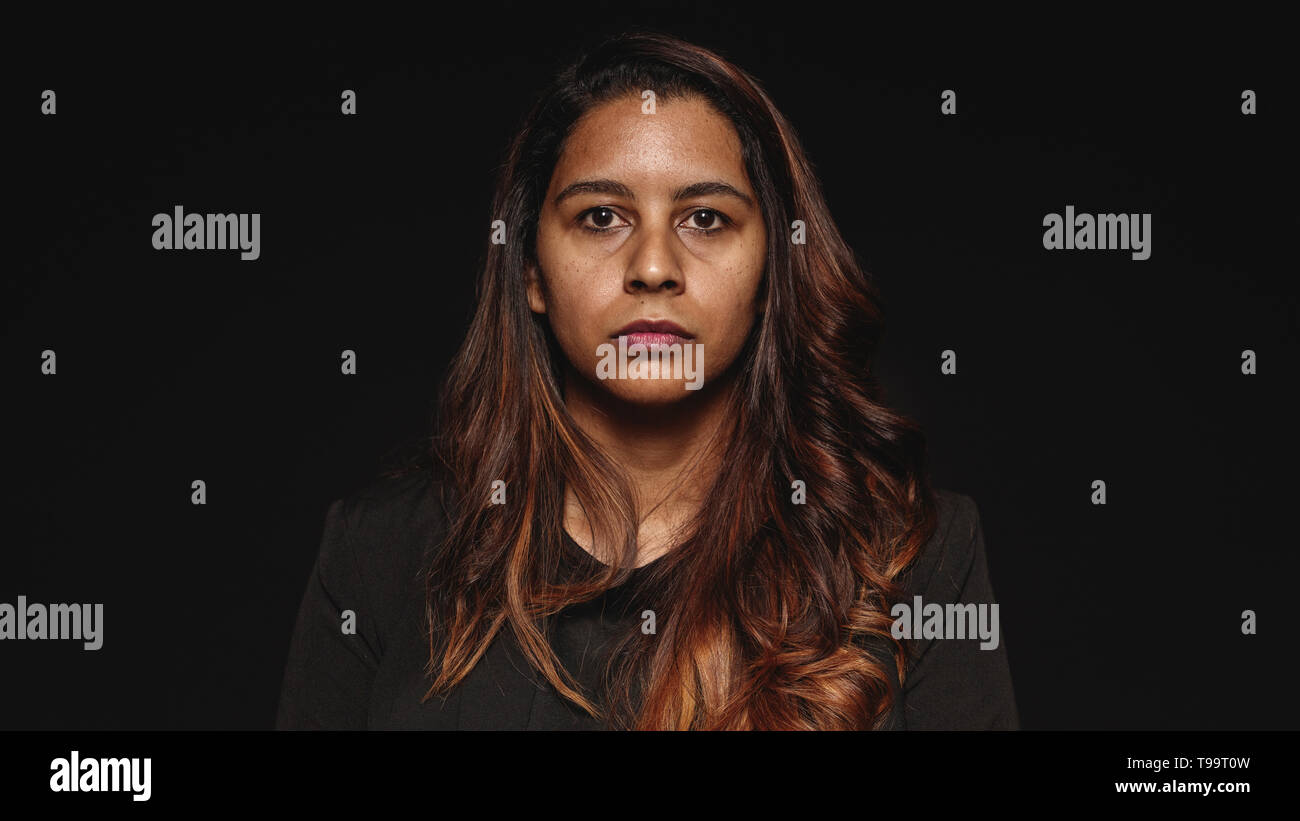 Close up of a businesswoman isolated on black background. Portrait of a ...