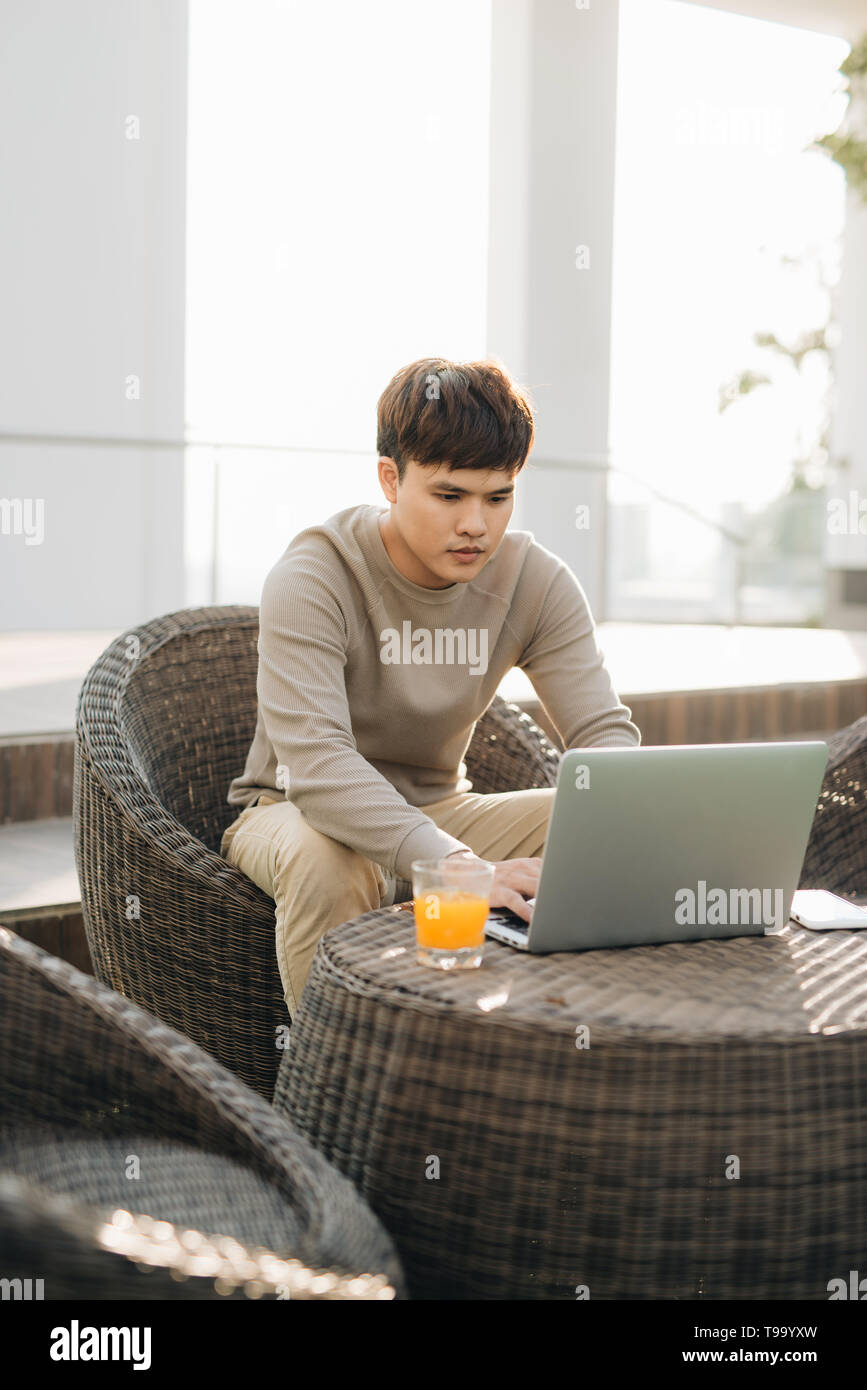 Businessman sitting on sofa typing hi-res stock photography and images ...
