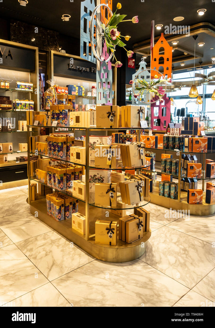 Display of boxes of Godiva Chocolates among other luxury chocolate brands in a retail unit at Schiphol Airport, Amsterdam, the Netherlands Stock Photo