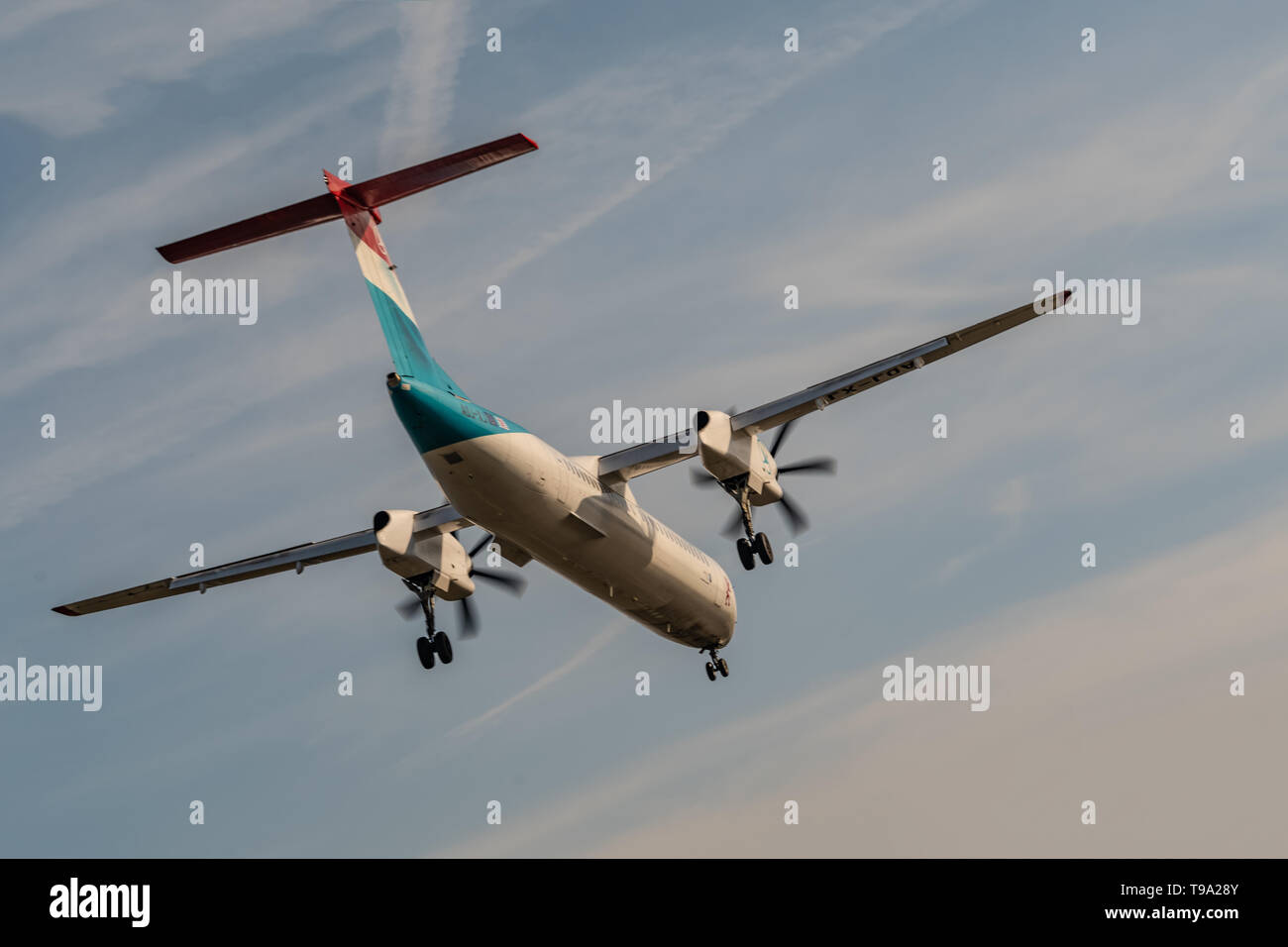 London, UK - 17, February 2019: Luxair a Luxembourg regional airline based in Luxembourg, aircraft type De Havilland Canada DHC-8-400 Fly on blue sky  Stock Photo
