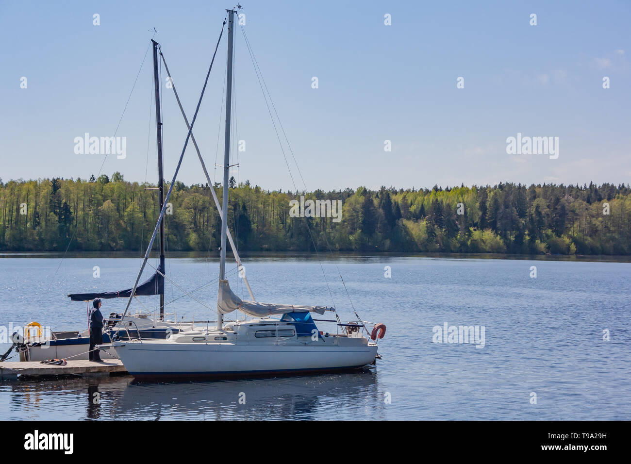 A river landscape with yachts. Moored yacht against the forest. Yacht in the river Stock Photo