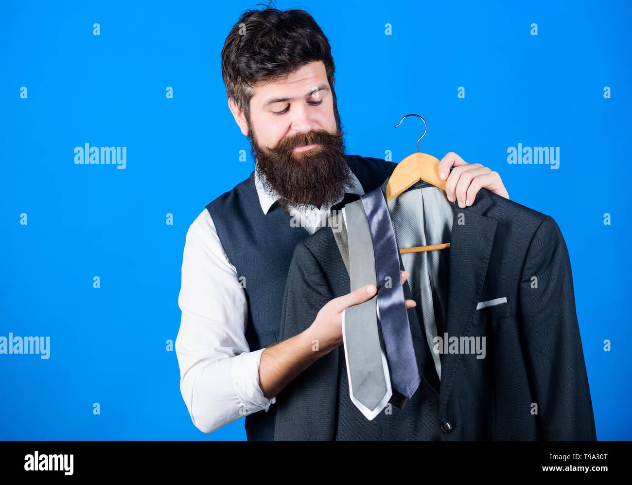 Shop assistant or personal stylist service. Stylist advice. Matching  necktie with outfit. Man bearded hipster hold neckties and formal suit. Guy  choosing necktie. Perfect necktie. Shopping concept Stock Photo - Alamy
