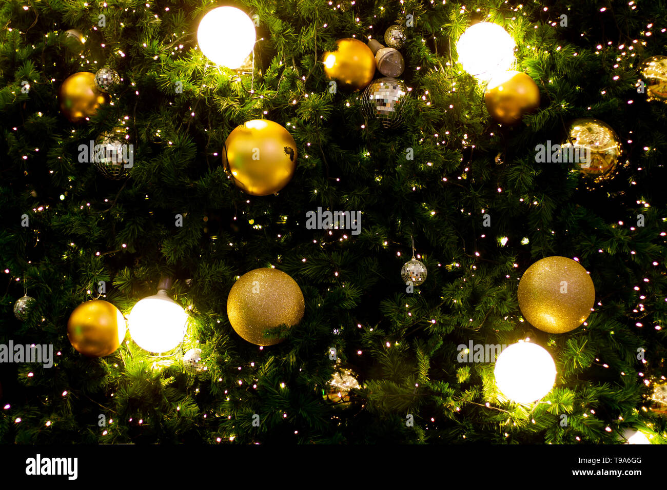 Christmas glowing Golden Background. Christmas lights. Gold Holiday New year Abstract Glitter De
