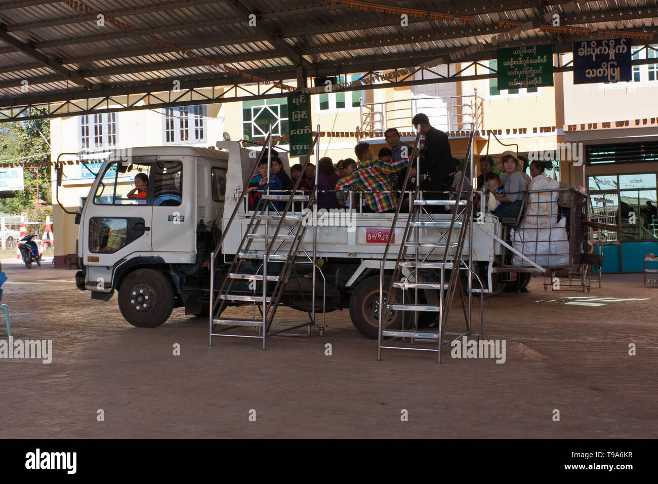 A bus station in Myanmar. The truck serves as a passenger vehicle Stock Photo