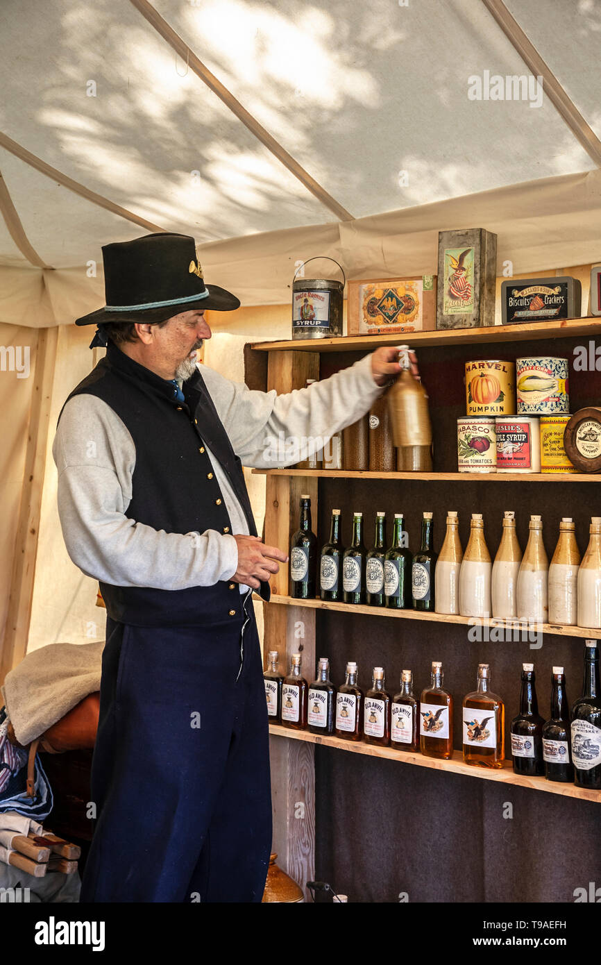 Civil War Era Union soldier reenactor at bottled goods display, Doc's Mercantile, Fort Stanton Live!, Fort Stanton, New Mexico USA Stock Photo