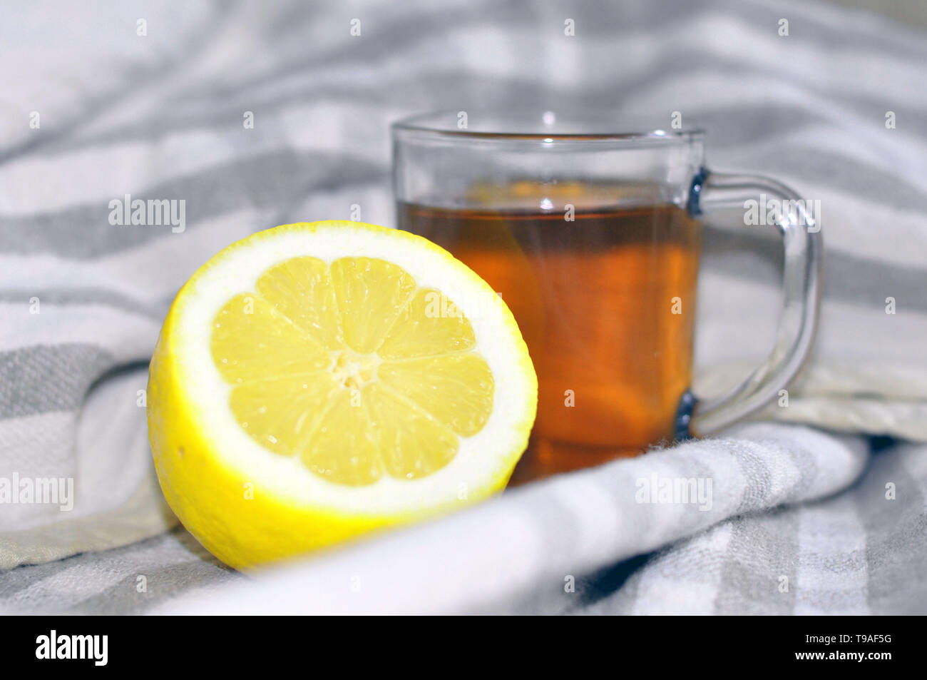 circling strong tea with lemon at the bedside. Health Stock Photo