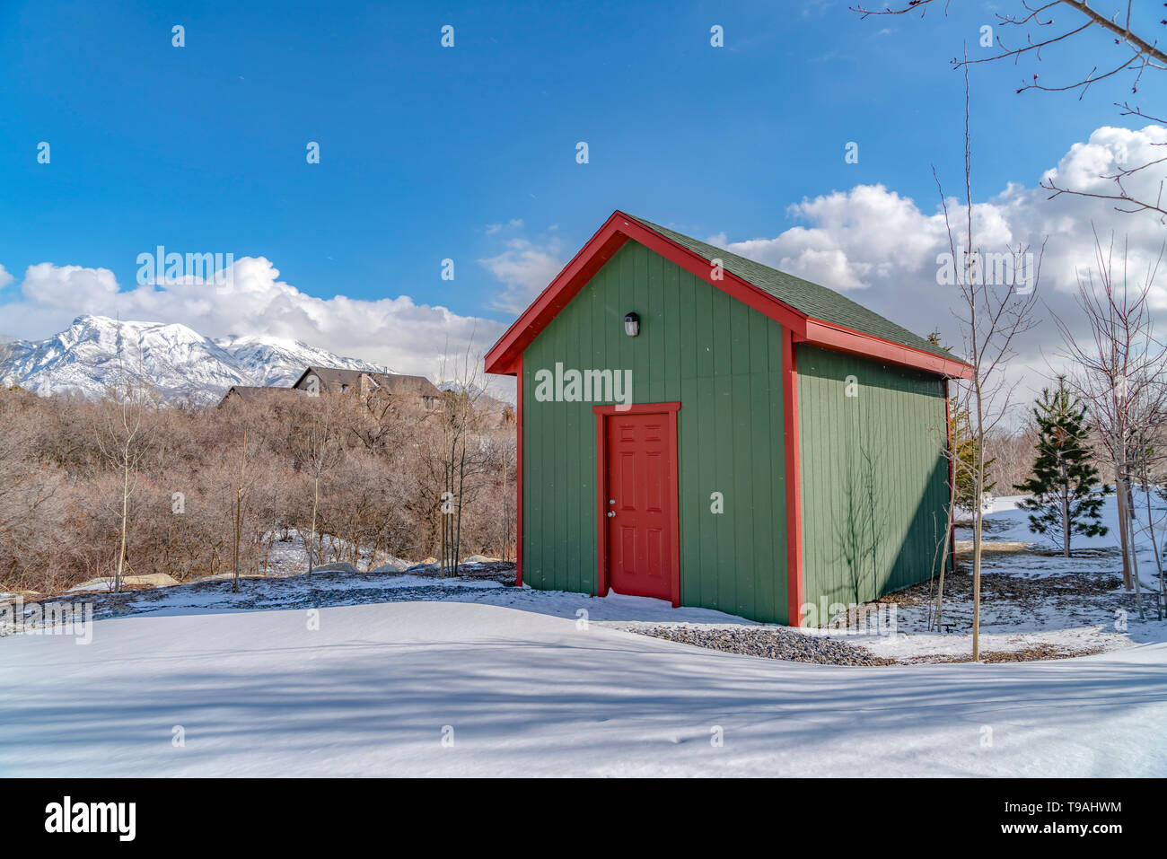 Exterior of a wooden storage shed built on a snow covered ground in winter Stock Photo