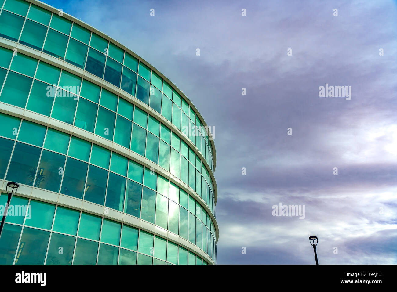 Exterior view of a modern office building with reflective glass wall ...