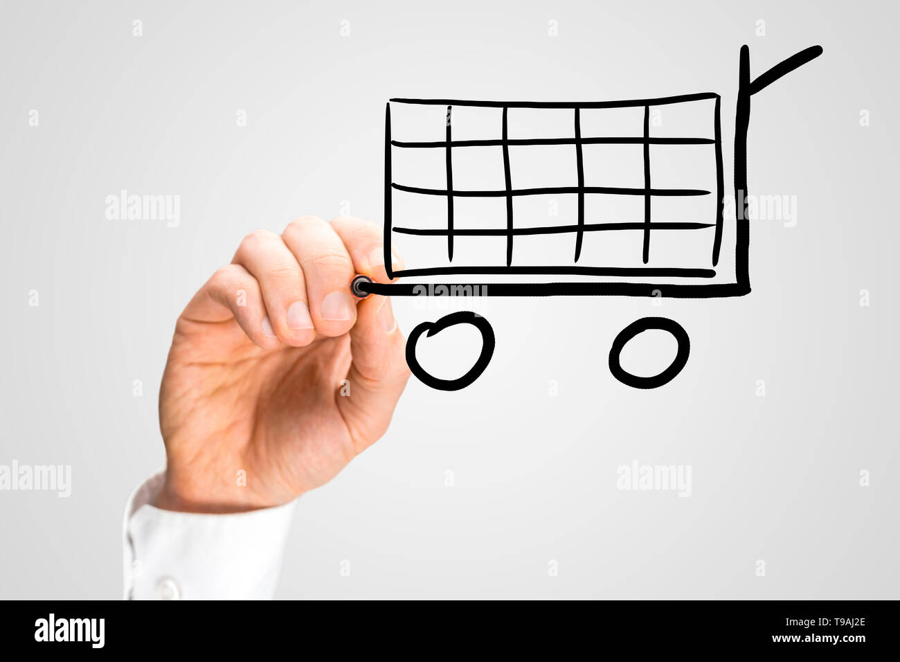 Male hand drawing shopping cart on virtual screen Stock Photo - Alamy