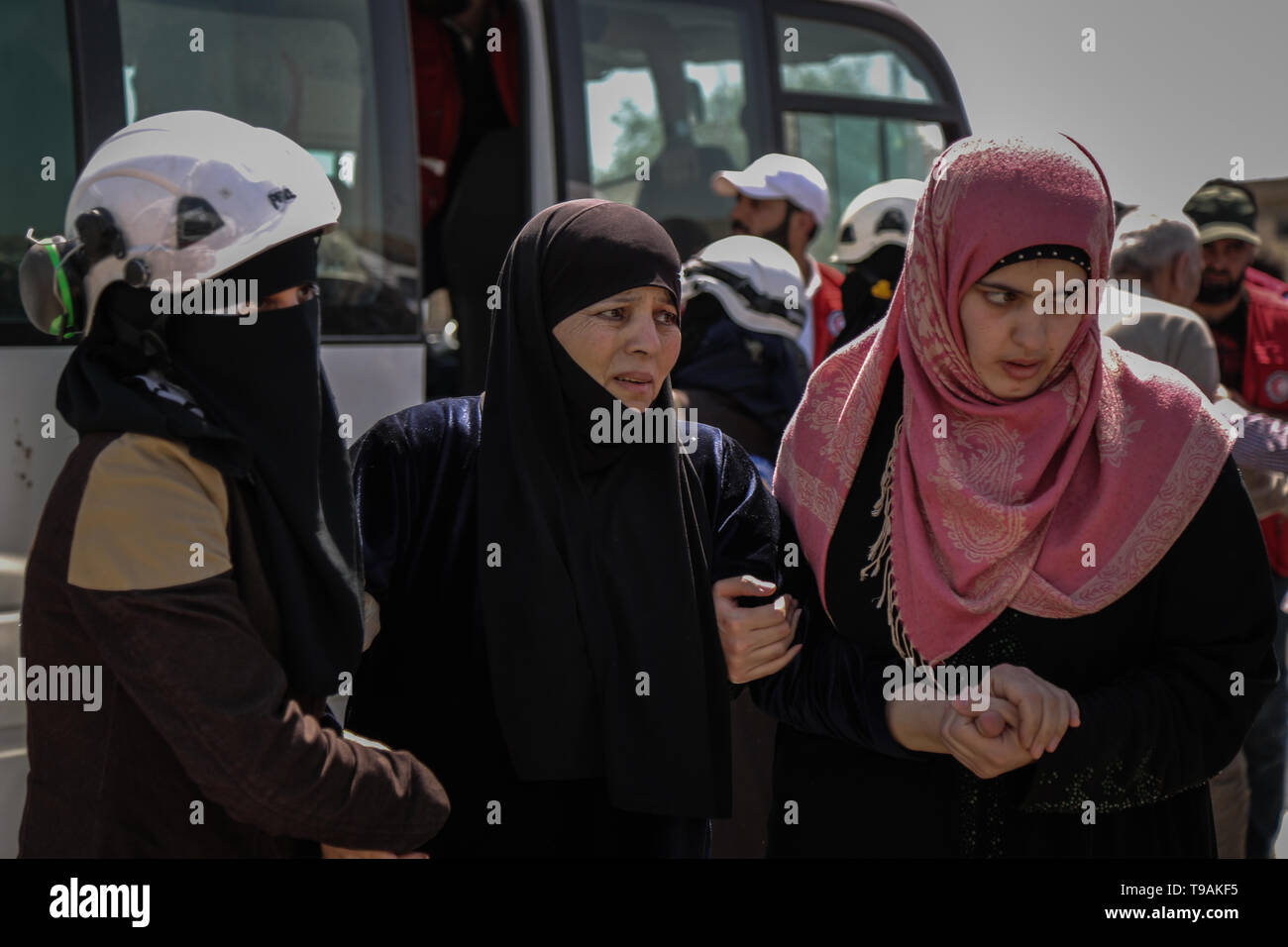 Al Ais, Syria. 17th May, 2019. Syrian women help another woman during a prisoner exchange between forces loyal to Syrian President Bashar Al-Assad and rebels of the Sham Liberation Army (Jaysh Tahrir al-Sham). 27 prisoners were released by the Syrian regime, 9 by the Syrian rebel group. Credit: Anas Alkharboutli/dpa/Alamy Live News Stock Photo