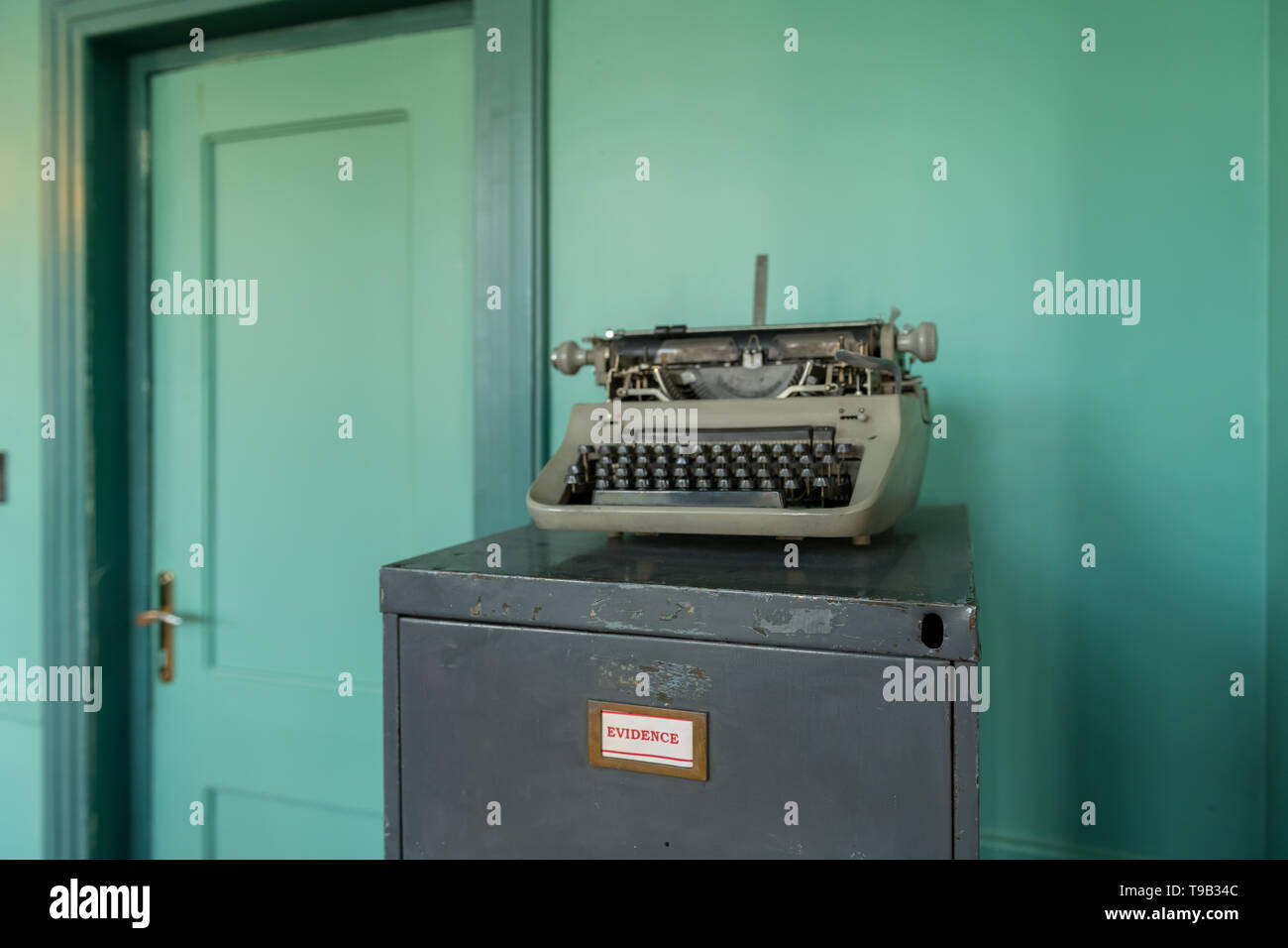 Office cabinet and typewriter in the former Embassy of the United States of America in Tehran. Stock Photo