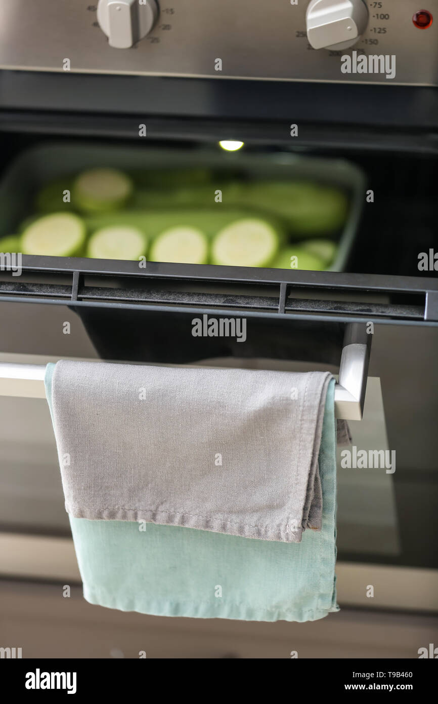 Clean kitchen towels on handle of electric oven Stock Photo Alamy