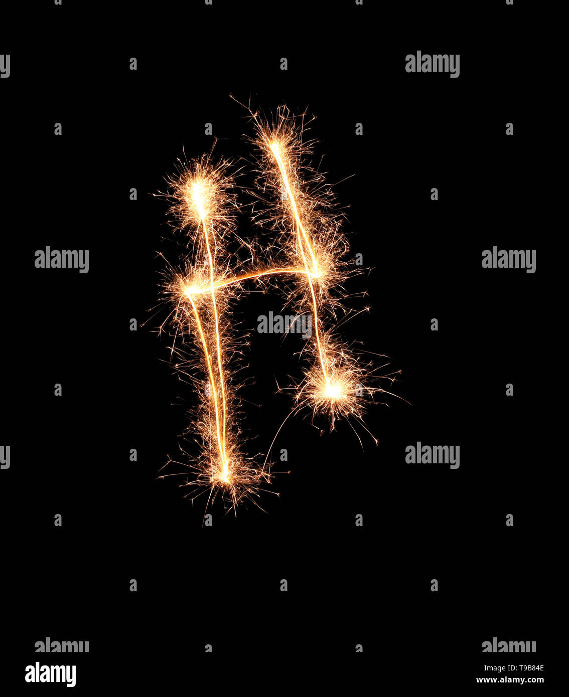 Sparklers forming letter H on dark background Stock Photo
