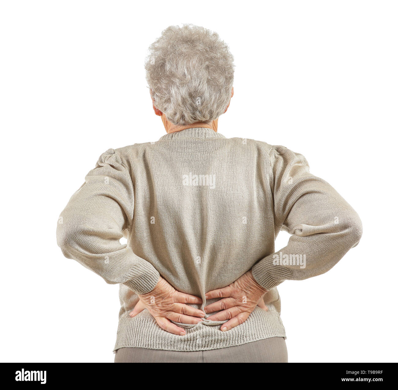 Senior woman suffering from back pain on white background Stock Photo ...