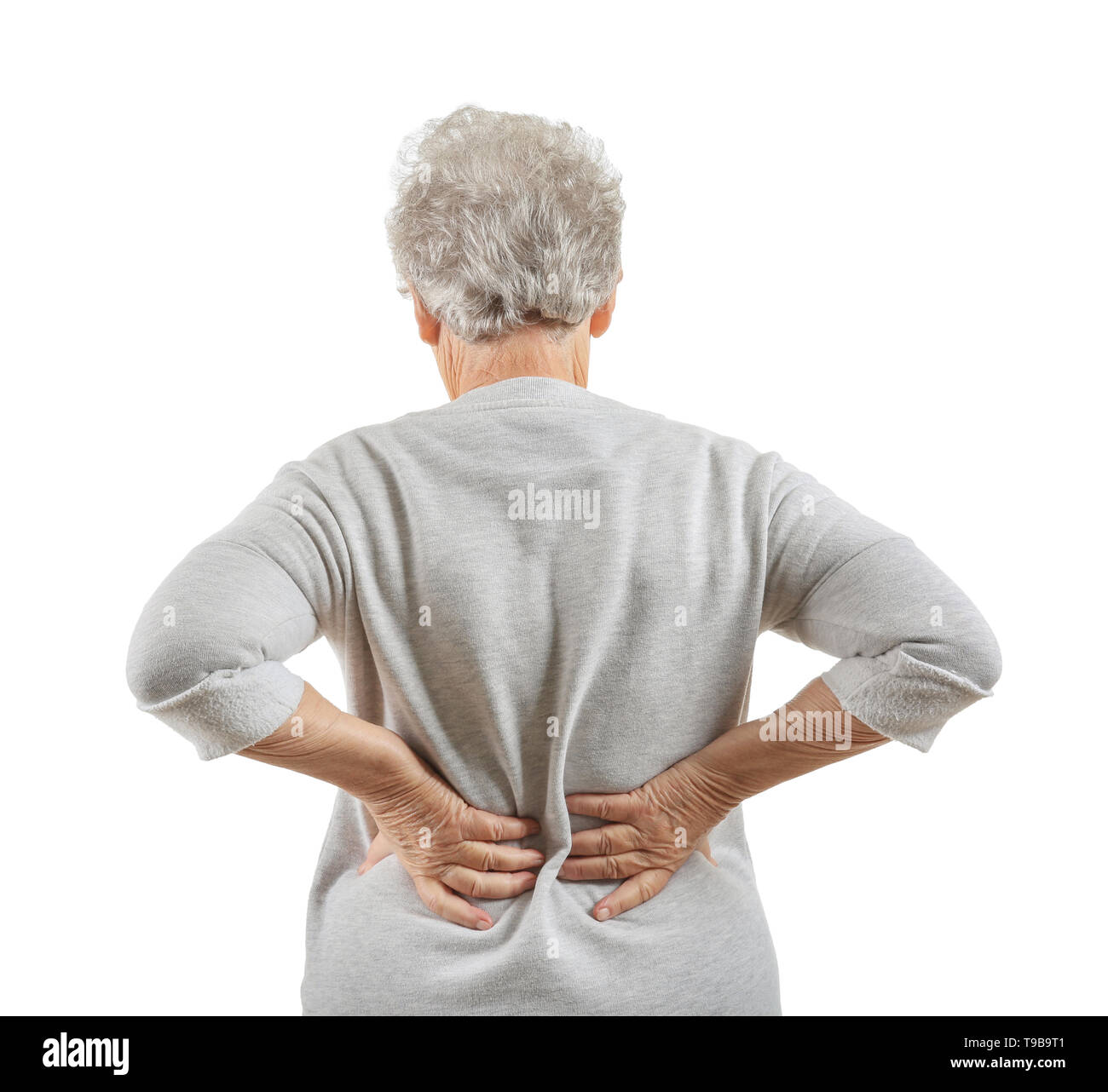 Senior woman suffering from back pain on white background Stock Photo ...