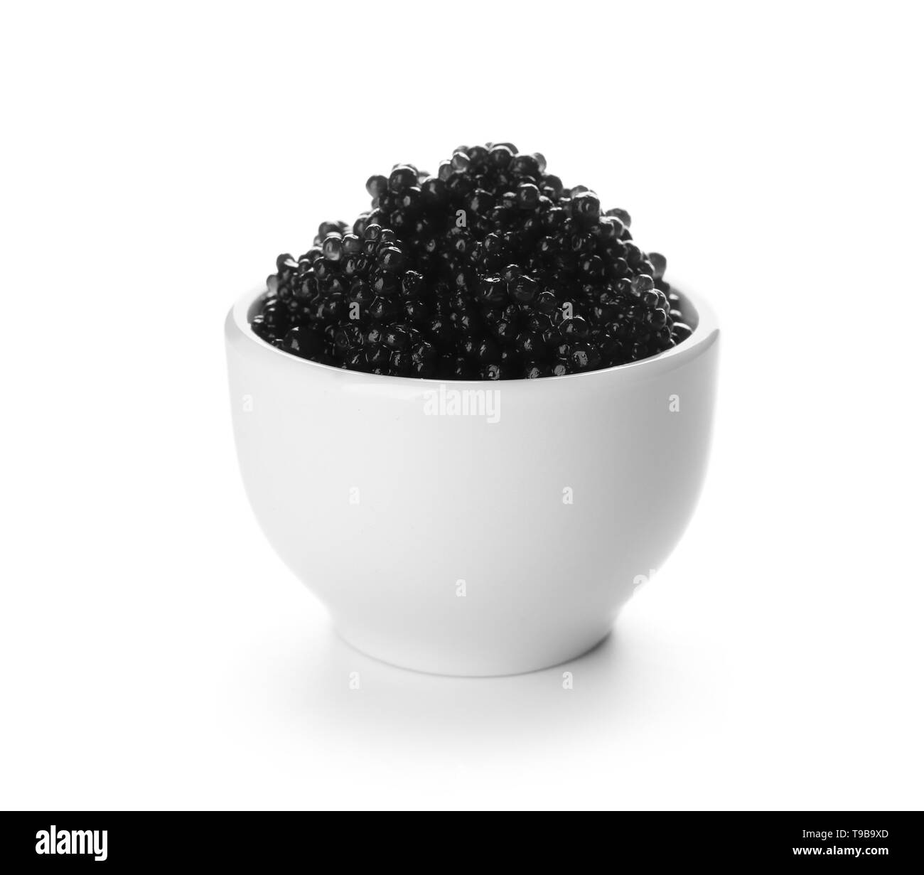 Bowl with delicious black caviar on white background Stock Photo - Alamy