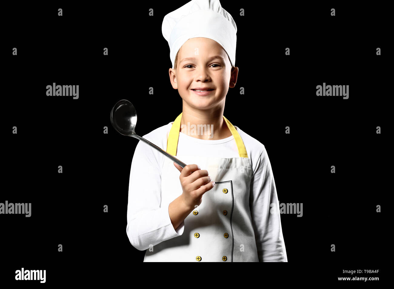 Cute little chef on dark background Stock Photo - Alamy