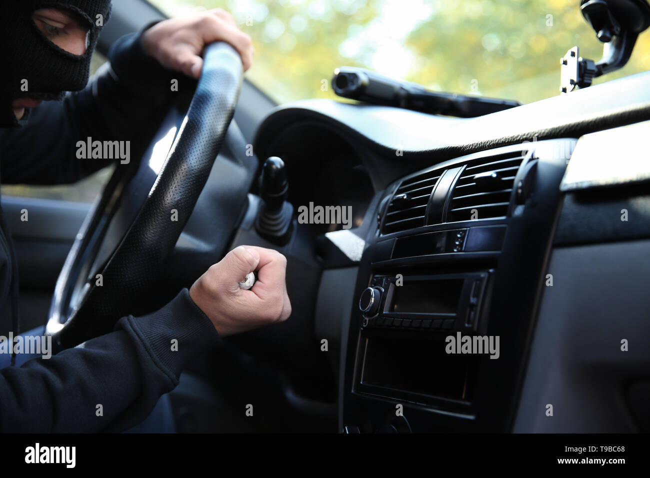 Male thief sitting in car Stock Photo