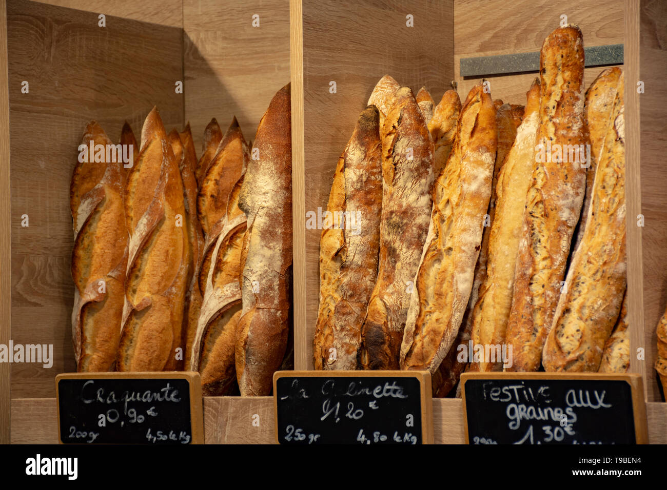 Freshly baked traditional baguettes and bread in small rustic bakery in Provence, South of France, close up Stock Photo