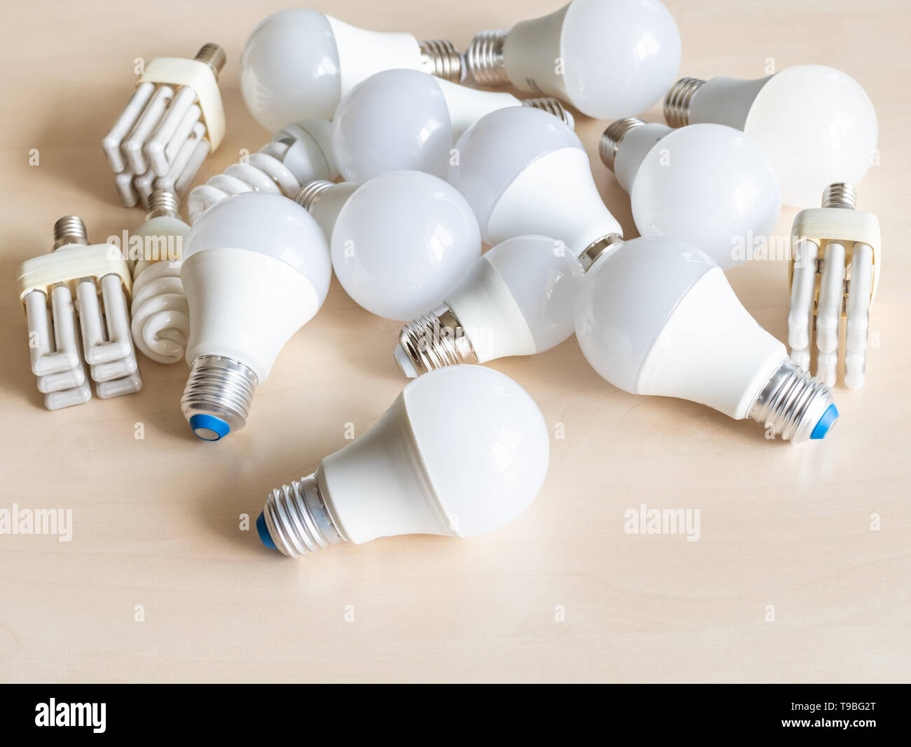 many various LED bulb lights and energy-saving lamps on table Stock Photo