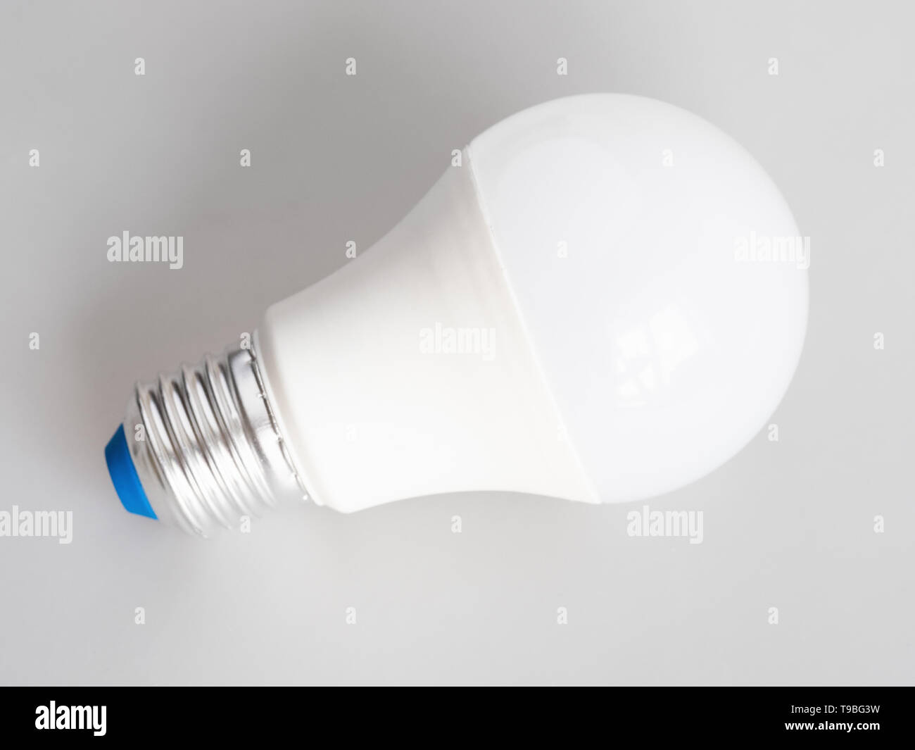 energy-saving household LED bulb light on gray background Stock Photo