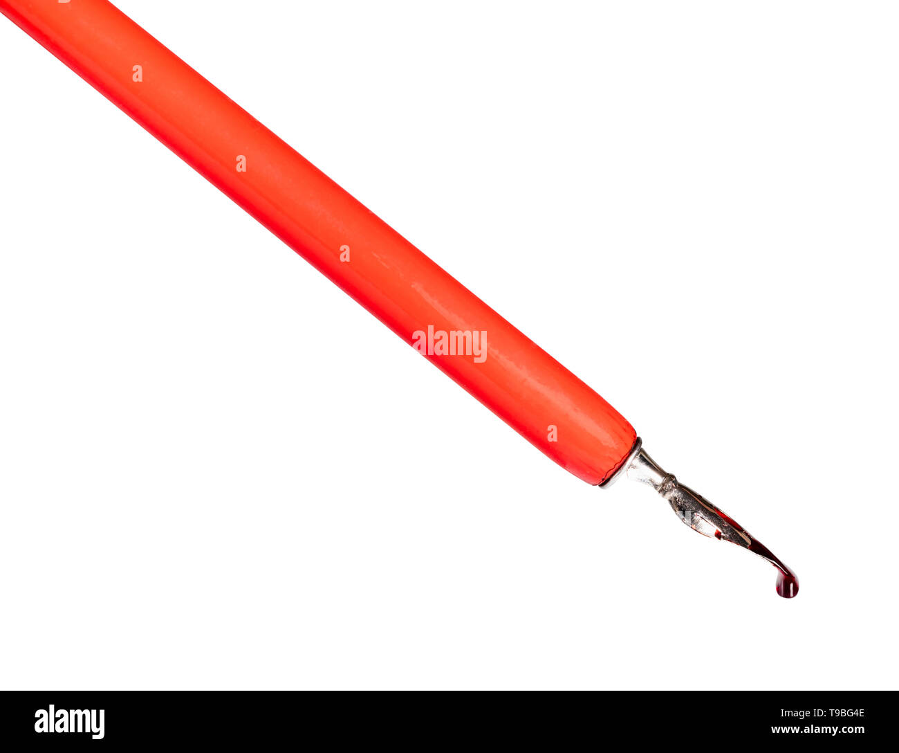 side view of red ink drop drips from sharp nib of dip pen cut out on ...