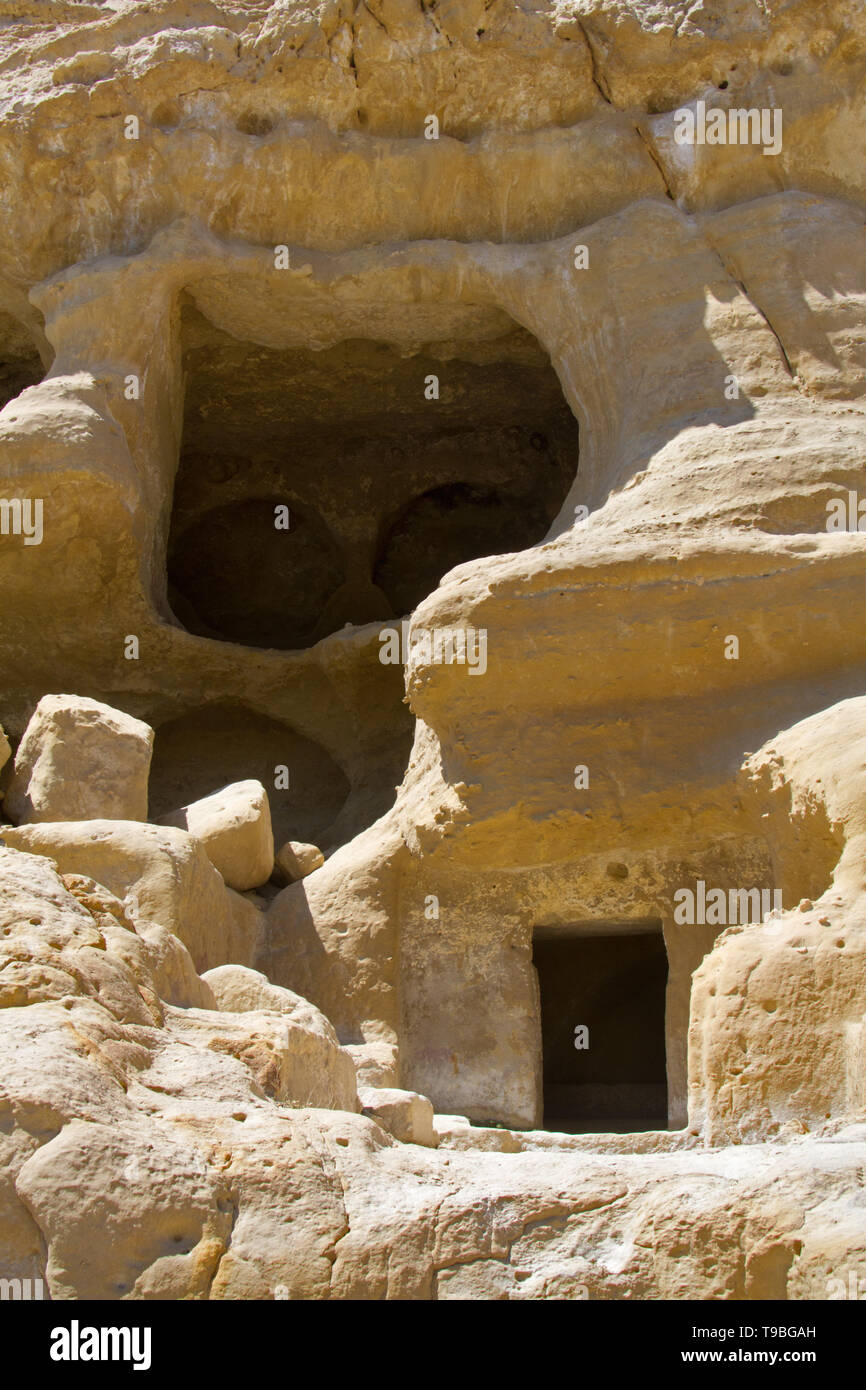 Early Christian tombs, carved out in the sandstone rocks near Matala on Crete Stock Photo