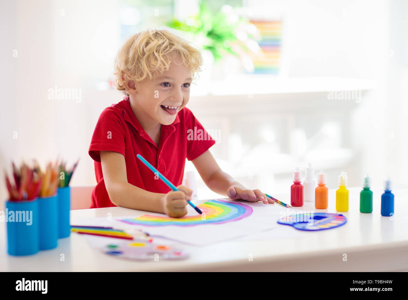 https://c8.alamy.com/comp/T9BH4W/kids-paint-child-painting-in-white-sunny-study-room-little-boy-drawing-rainbow-school-kid-doing-art-homework-arts-and-crafts-for-kids-paint-on-ch-T9BH4W.jpg