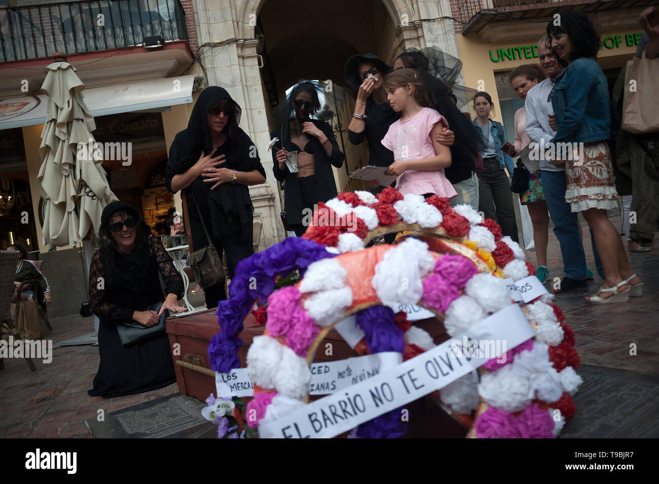 Flowers seen next to a coffin during the protest. The association of down town neighbours from Malaga have organized a symbolic funeral of a neighbour as part of a performance against the high cost of housing and rent because of property speculation in Malaga centre. Stock Photo