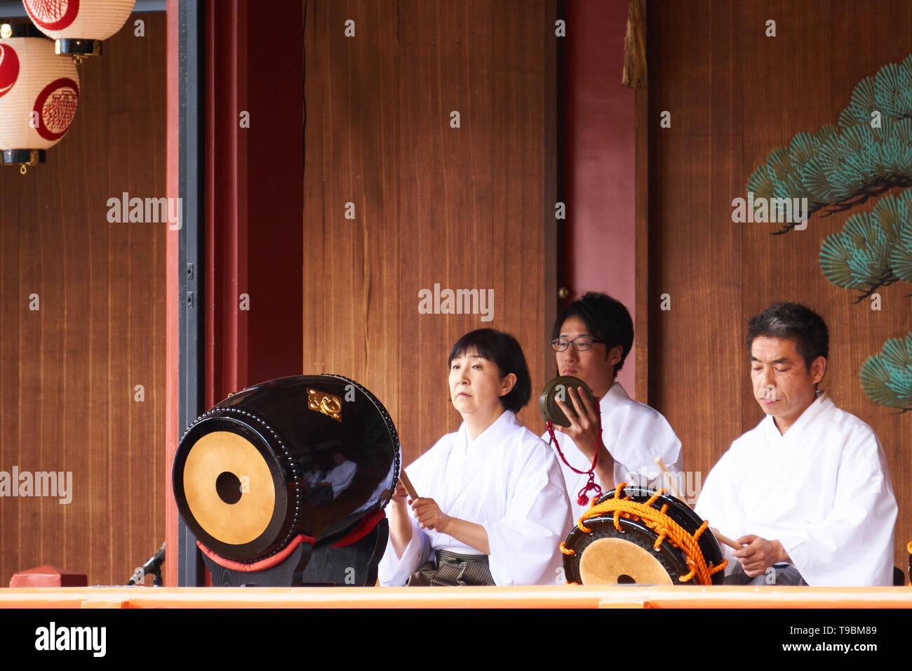 Japanese men and a woman musicians play traditional instruments gagaku