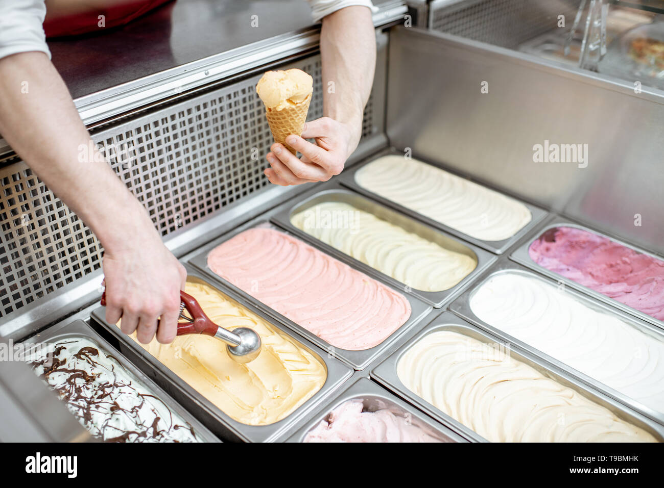 Metal trays full of colorful ice cream in the showcase
