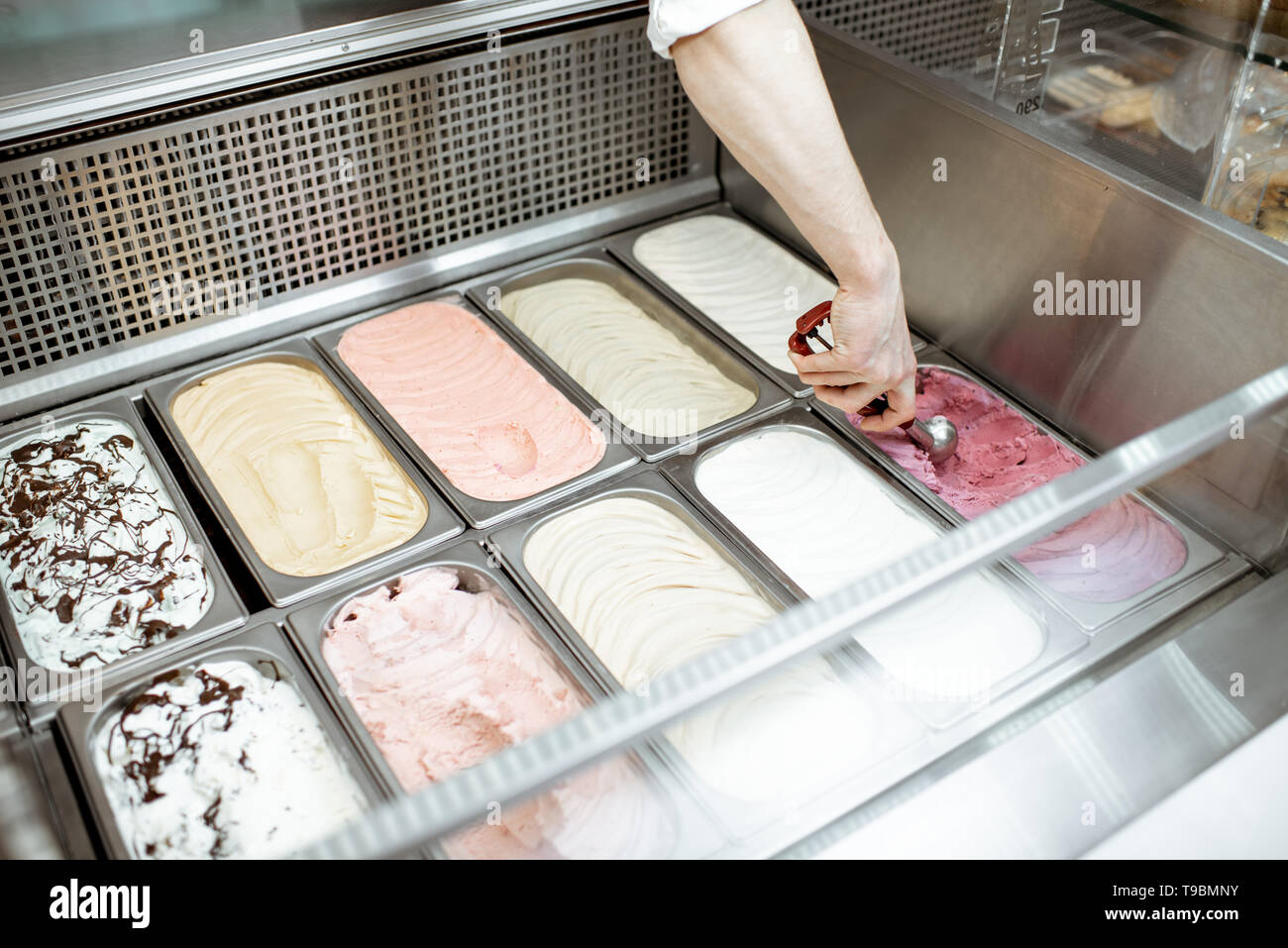 Man Taking Ice Cream From The Metal Trays With Scoop In The Refrigerator At The Shop Close Up View Stock Photo Alamy https www alamy com man taking ice cream from the metal trays with scoop in the refrigerator at the shop close up view image246734823 html