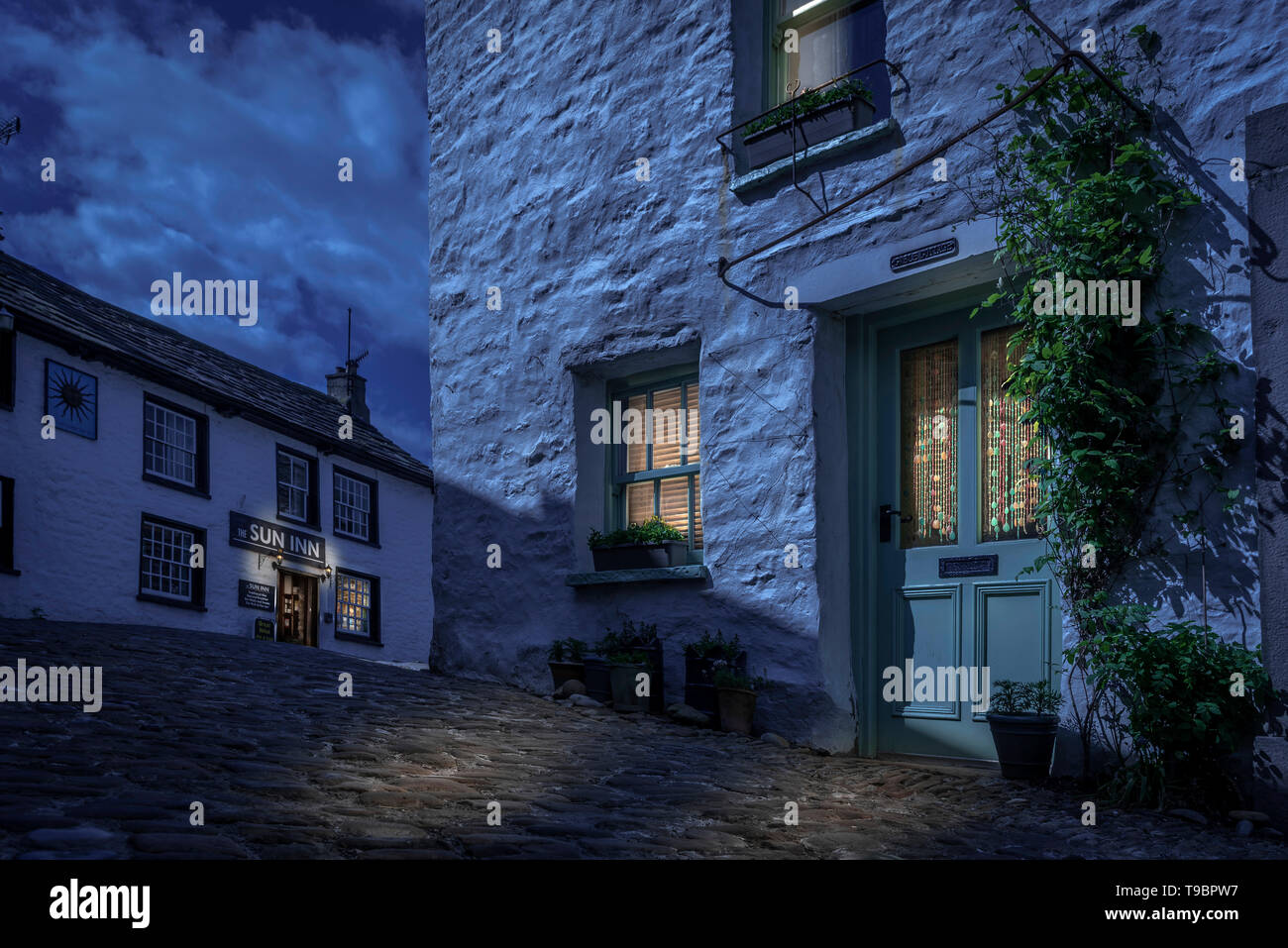 Dent village, Cumbria., Main street and Sun Inn. Photoshop nightime version. Stock Photo