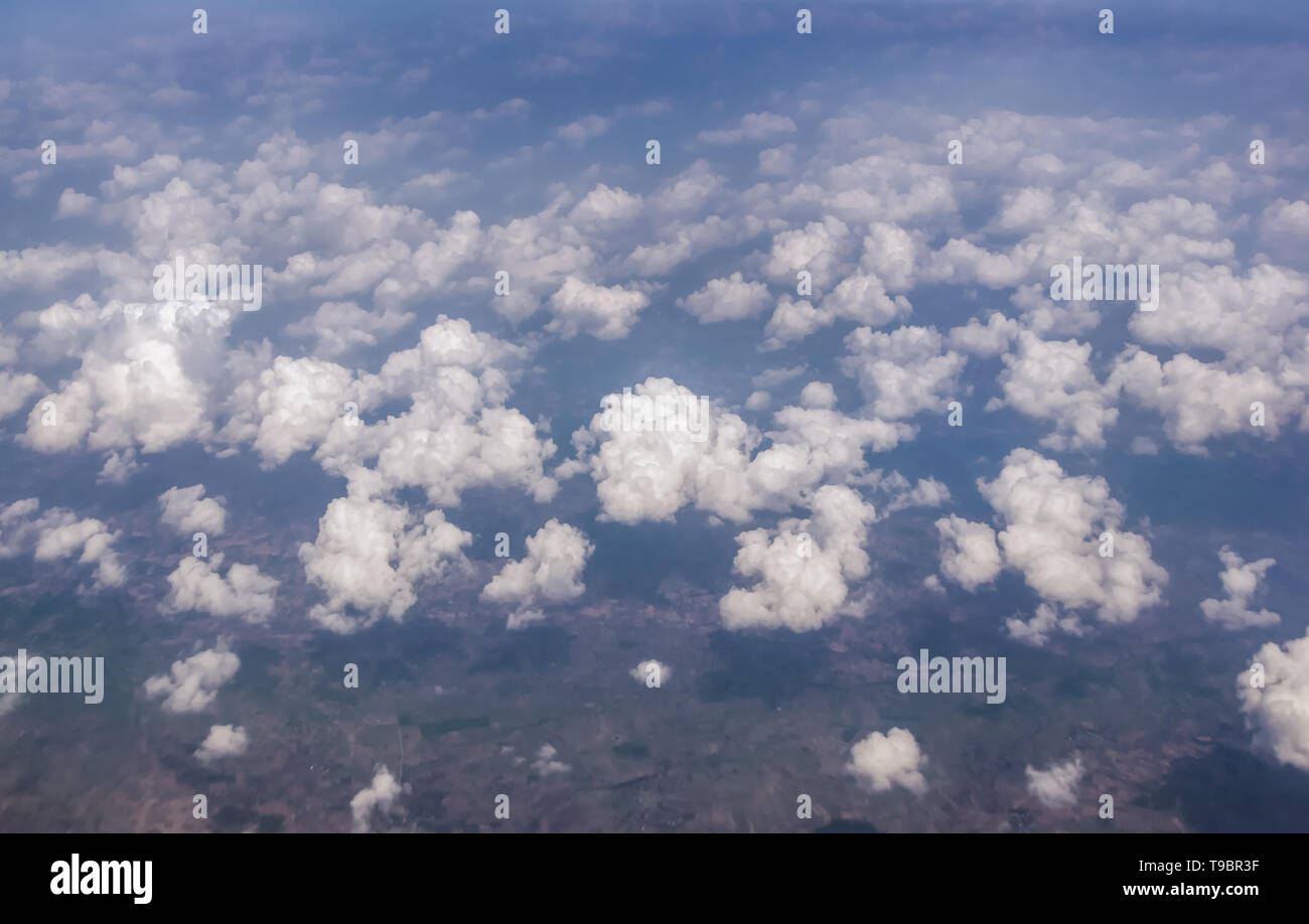 View of the sky clouds above the clouds from airplane window Stock Photo