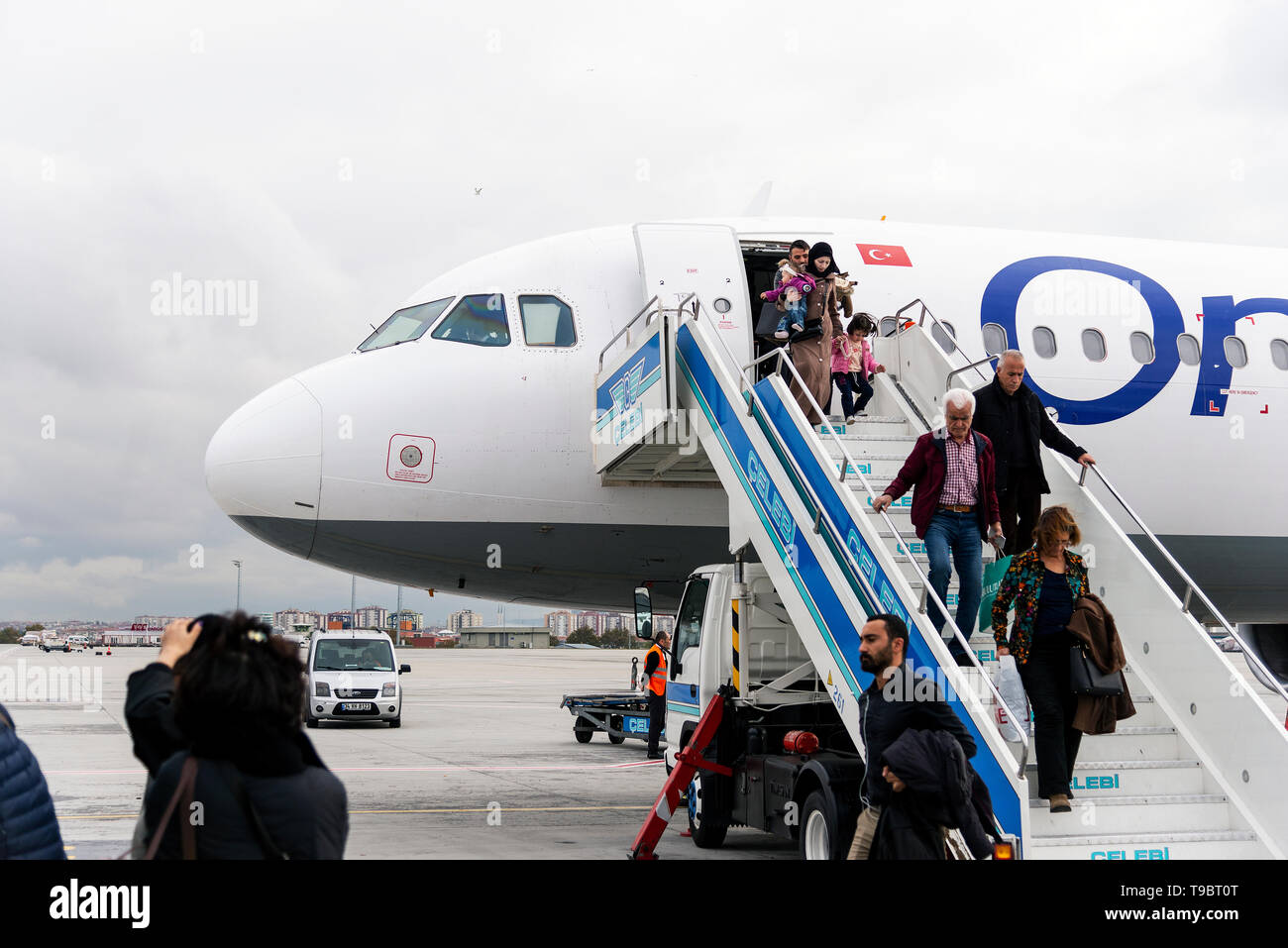 Izmir, Turkey - November 17, 2018. Istanbul airport which is out of service now. Passengers are getting off from an Onur air commercial plane for get  Stock Photo
