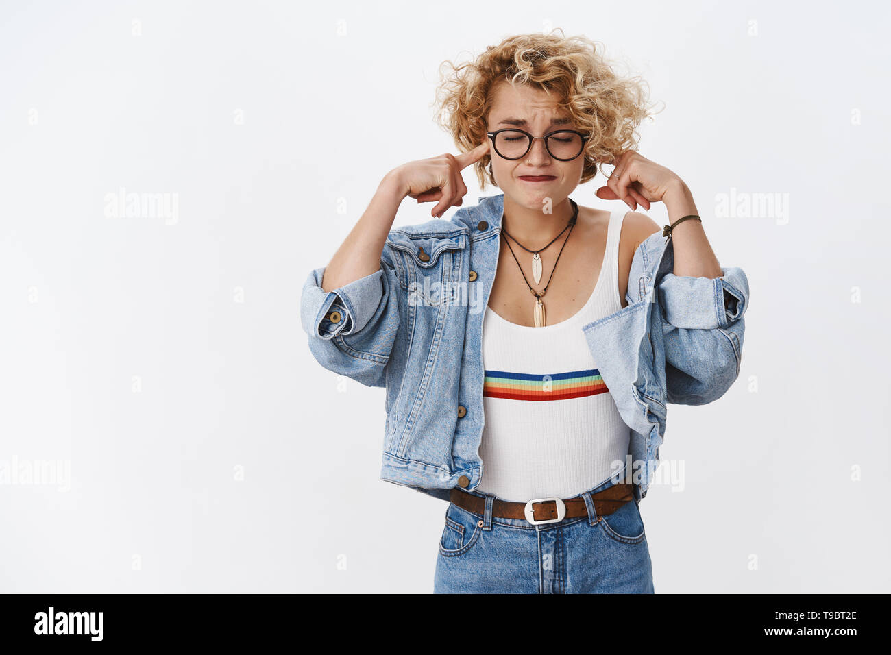 Girl cannot focus feeling upset as disturbed by loud noise pursing lips