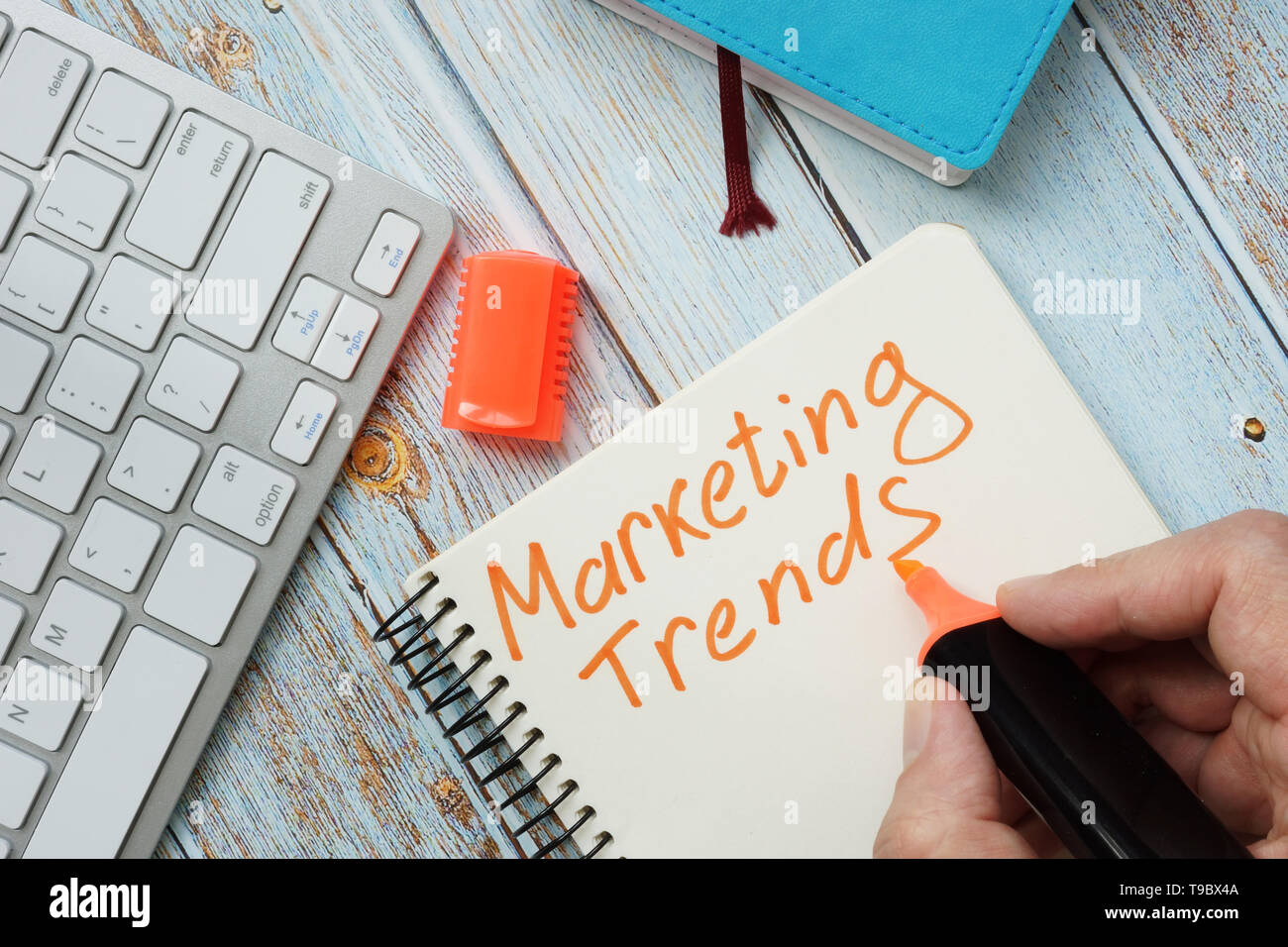 Man is writing marketing trends. Stock Photo