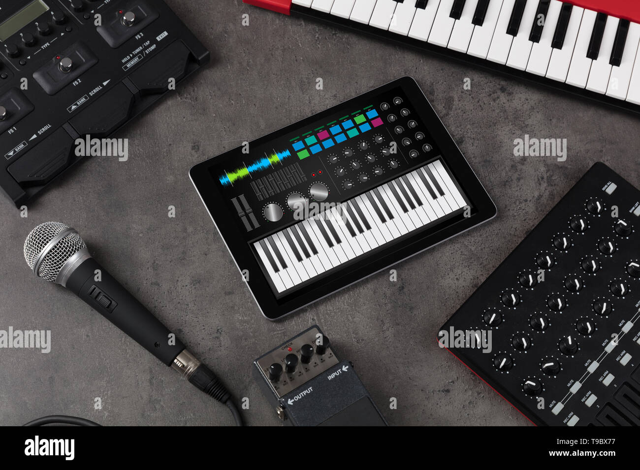 Piano synthesizer app on tablet and musical instrument concept Stock
