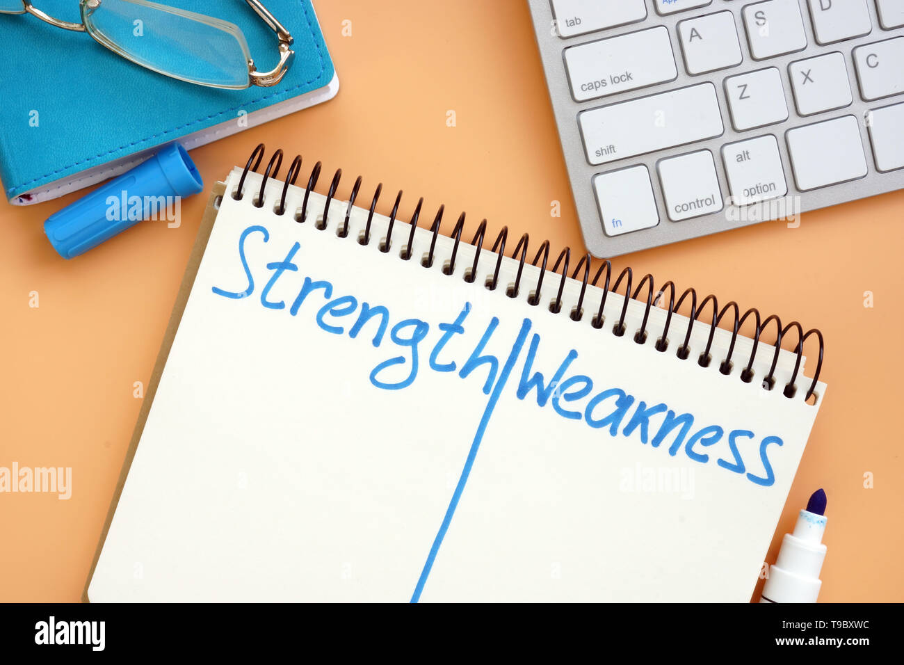 Strength and weakness list in the notepad. Stock Photo