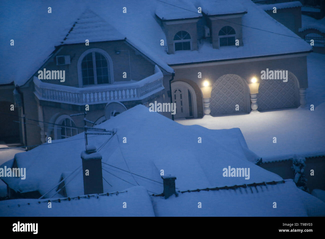 Beautiful winter view of houses and buildings with roofs covered with ...