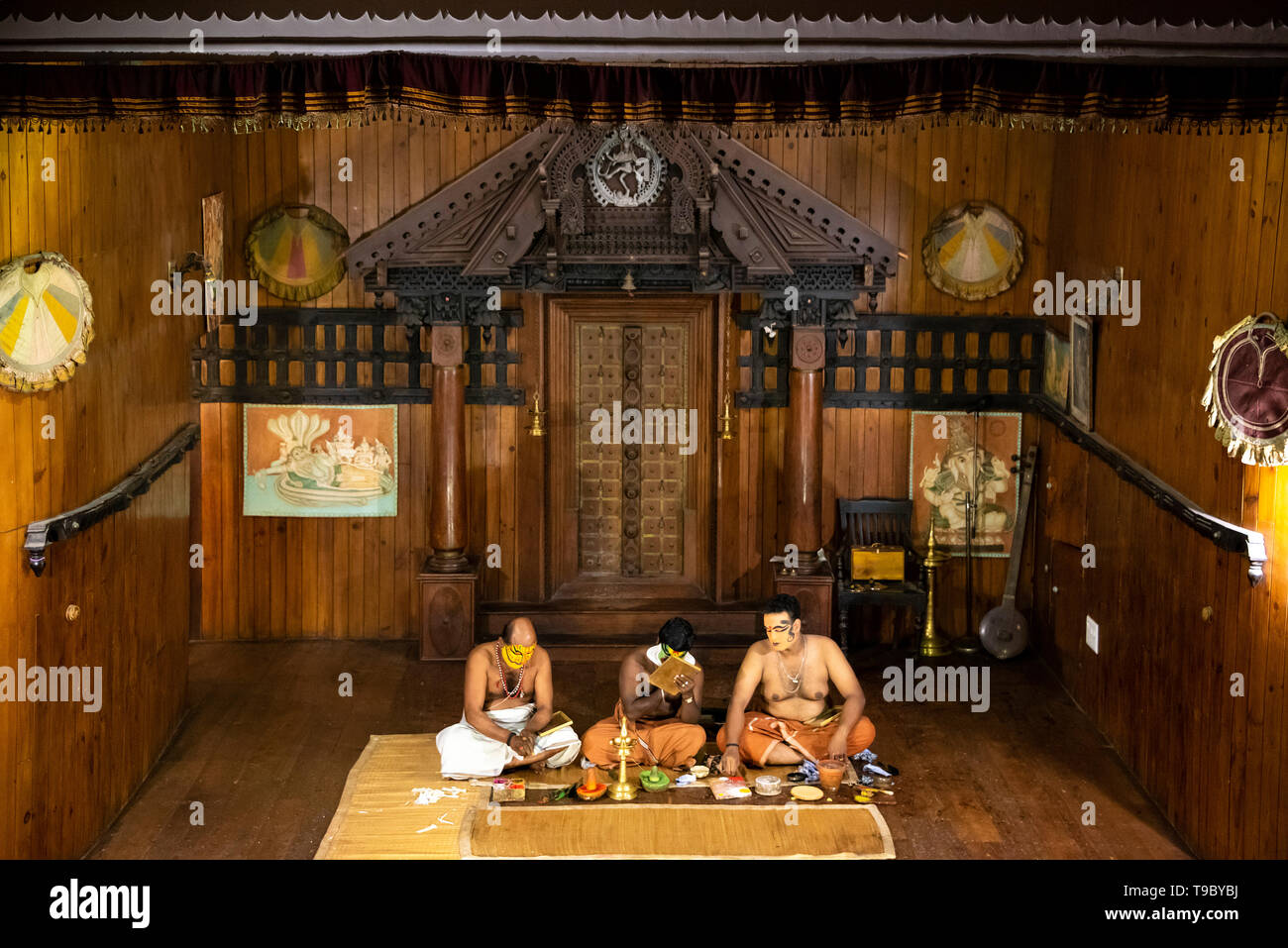 Horizontal aerial view of Kathakali performers putting on their distinctive make up in Kerala, India. Stock Photo