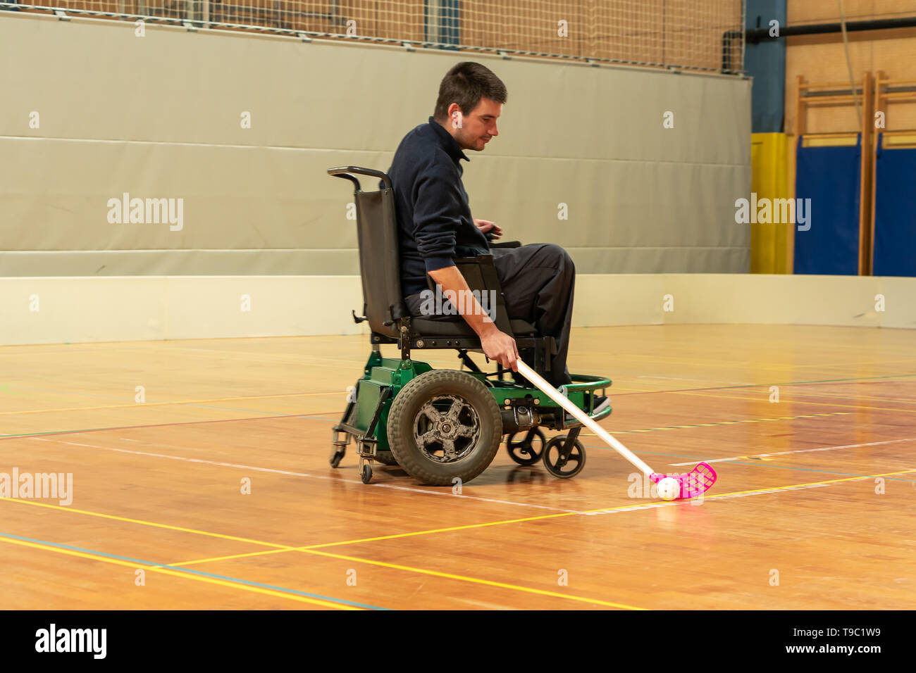 Disabled man on an electric wheelchair playing sports, powerchair