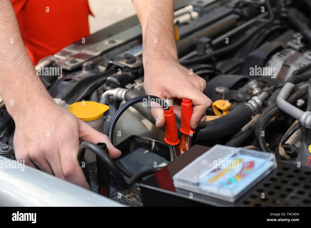 Male mechanic charging a car battery Stock Photo Alamy