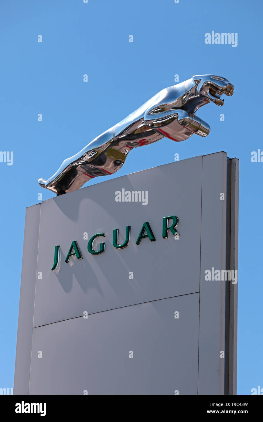 Jaguar Dealership sign with sculpted silver Jaguar Cat emblem Stock Photo