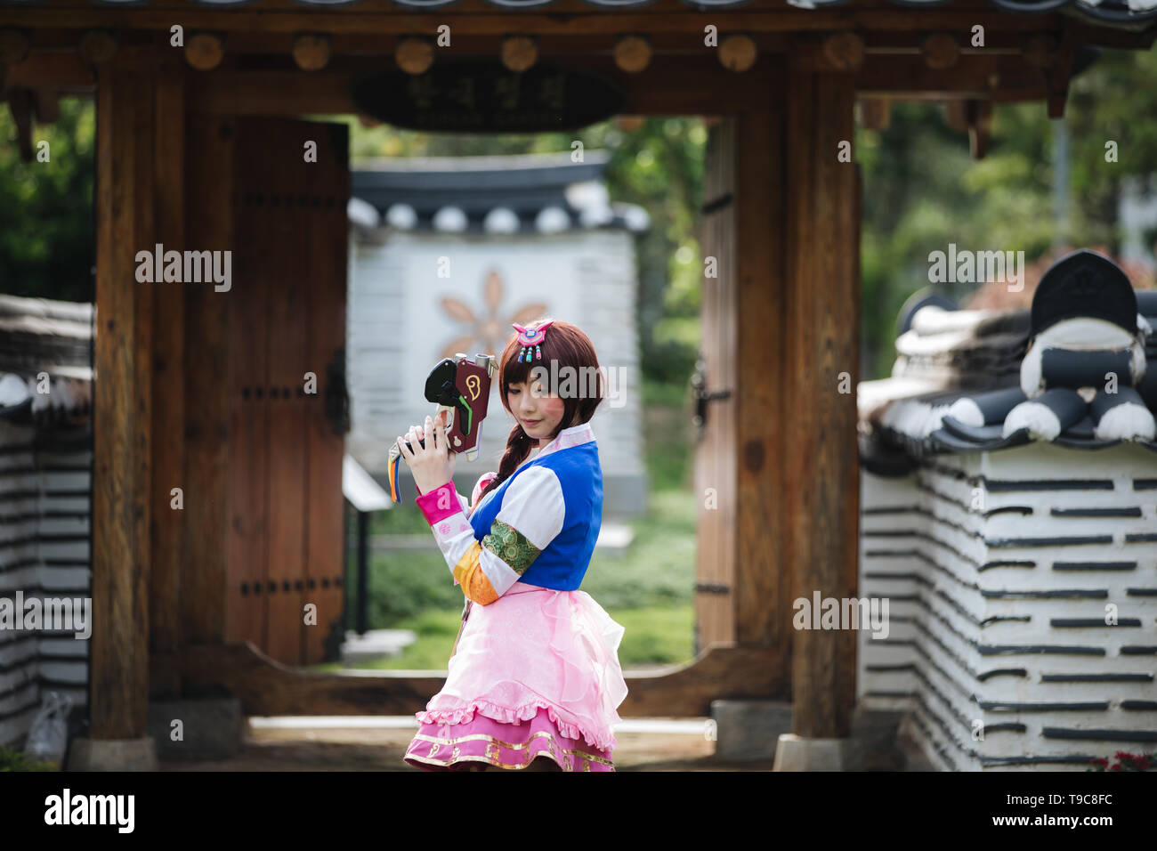 Portrait of Hanbok costume young woman looking and smile in korean park Stock Photo