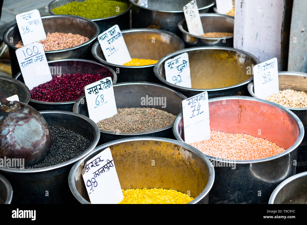 Pulses placed in steel drums with price tags ready for sale Stock Photo