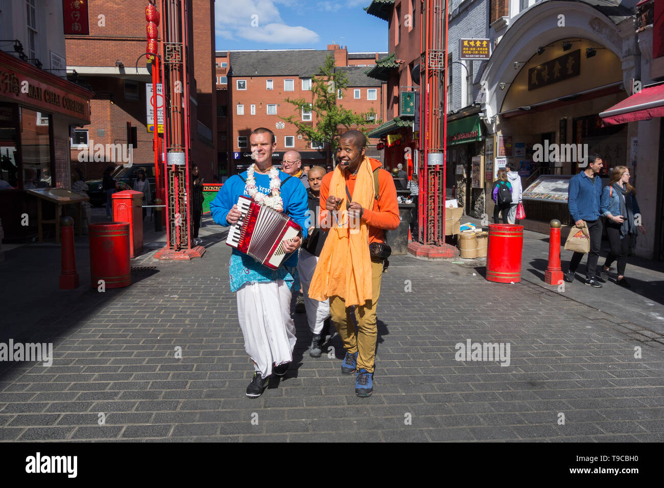 Hare Krishna followers and devotees making music and chanting in London's China Town, Soho, London, UK Stock Photo