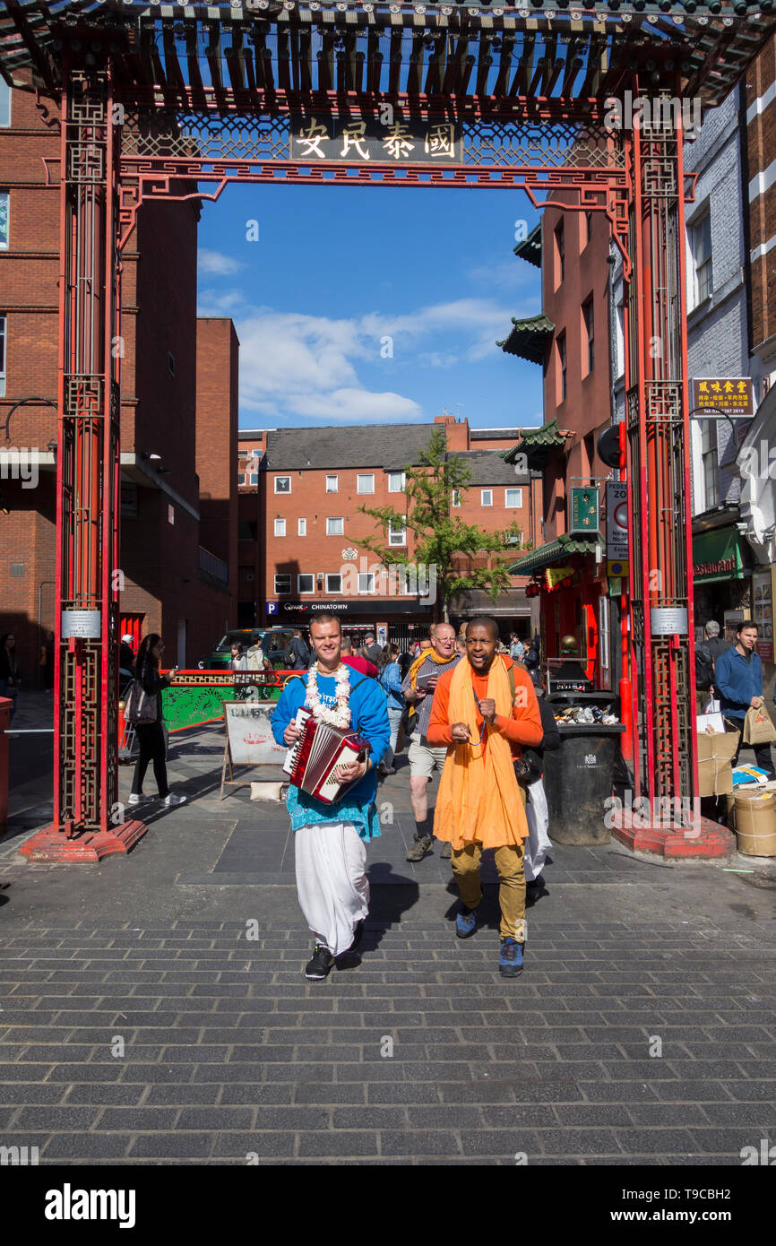 Hare Krishna followers and devotees making music and chanting in London's China Town, Soho, London, UK Stock Photo