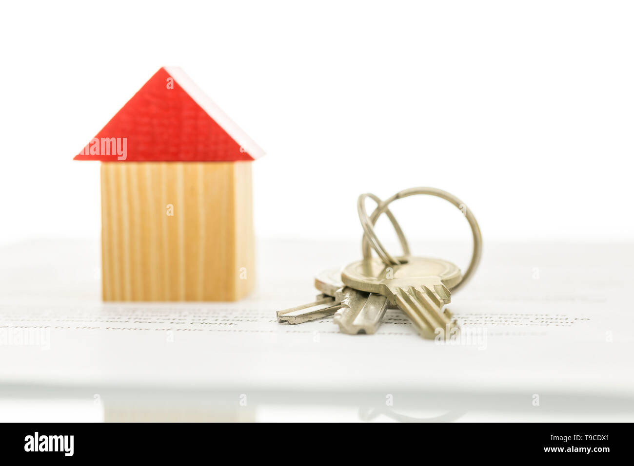 Wooden Toy House And House Keys On Contract Of House Sale Real