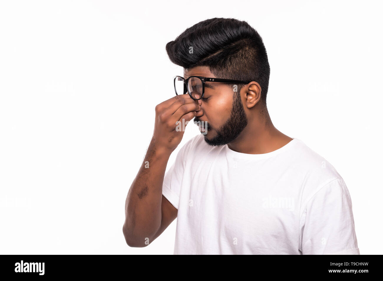Studio shot of young stressed Indian man having headache Stock Photo ...